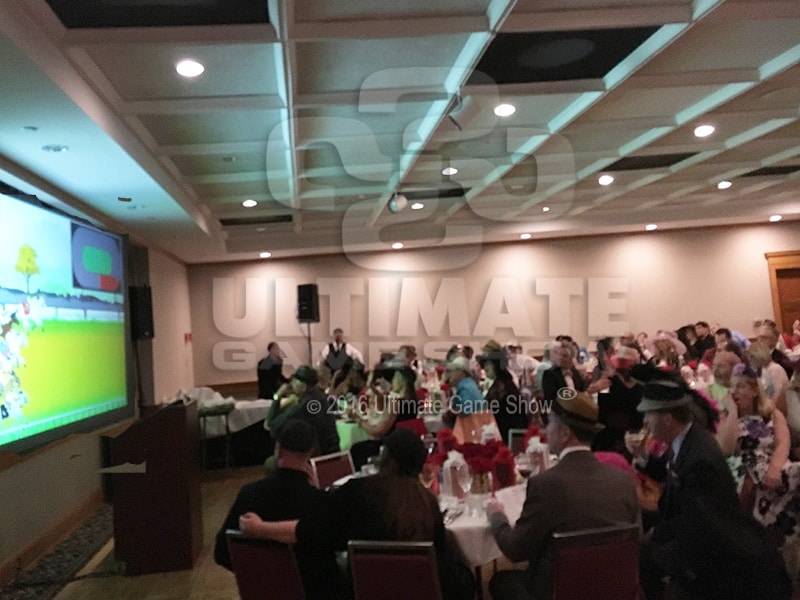 A group cheers on the favorite horses with Ultimate Derby animated horse racing from Bryan Quinn Productions
